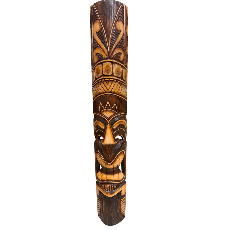 Wooden tiki mask with intricate carvings on a white background