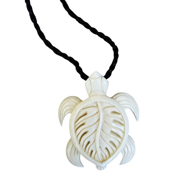 White turtle pendant on a black cord against a white background