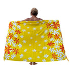 Person wearing a yellow floral patterned towel on a white background