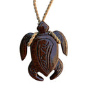 Wooden turtle pendant on a rope against a white background