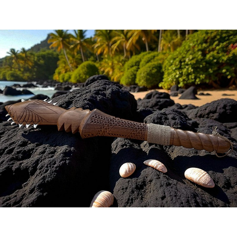 Decorative wooden staff with carvings on a black volcanic rock surface with a tropical beach background.