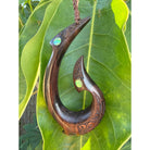 Wooden hook pendant with green gemstones on a leaf