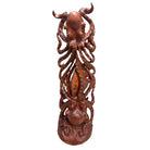 Wooden carvings of octopus and fish on a white background