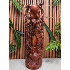 Carved wooden sculpture with intricate designs against a bamboo background