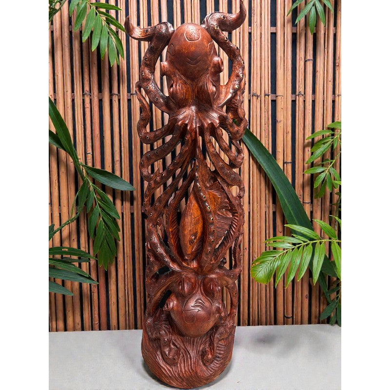 Carved wooden sculpture with intricate designs against a bamboo background