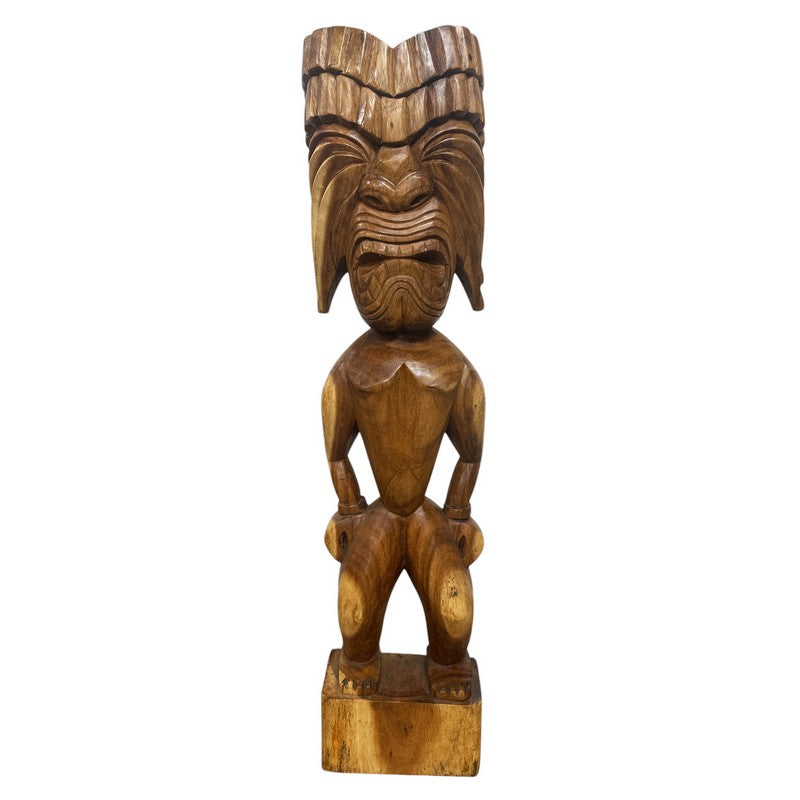 Wooden tiki statue with detailed carvings on a white background