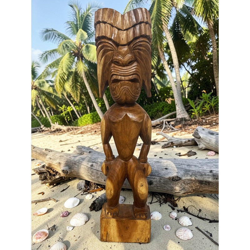 Wooden tiki statue on a beach with palm trees in the background