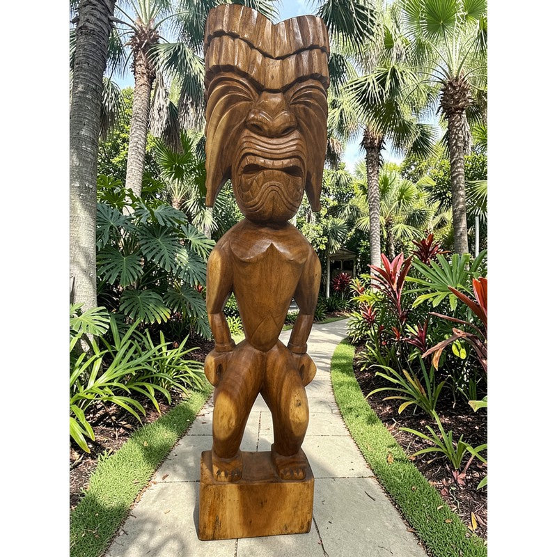 Wooden tiki statue in a tropical garden setting