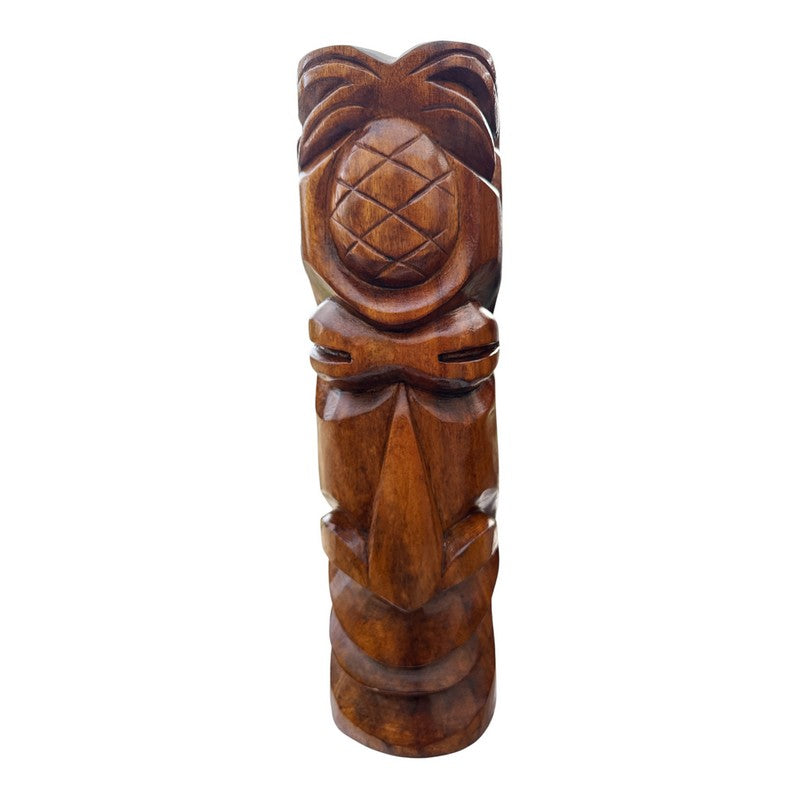 Wooden tiki statue with pineapple design on a white background